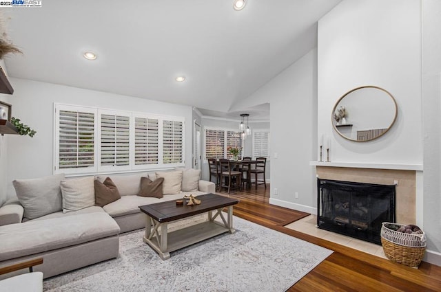 living room featuring light hardwood / wood-style flooring and high vaulted ceiling