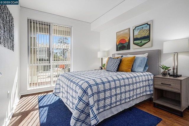 bedroom with dark hardwood / wood-style flooring and access to exterior