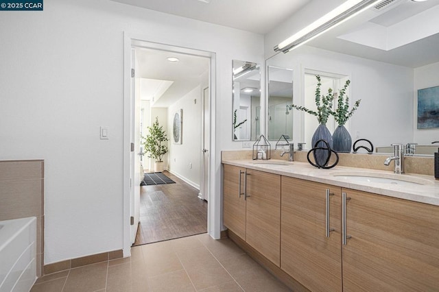 bathroom with tile patterned flooring and vanity