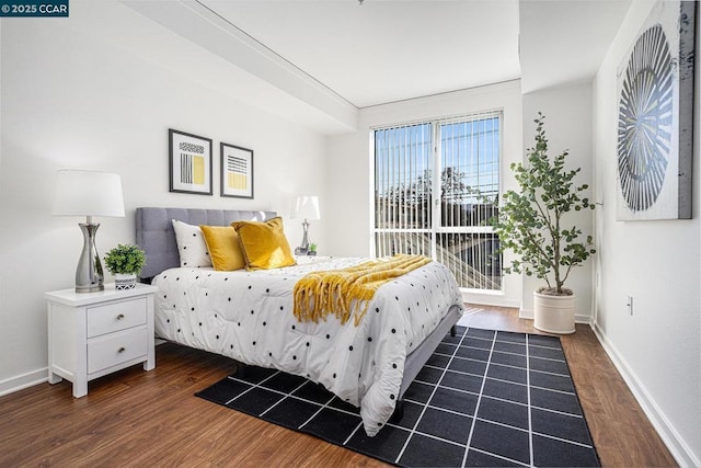 bedroom with dark wood-type flooring