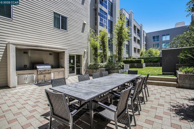 view of patio / terrace featuring a grill and exterior kitchen