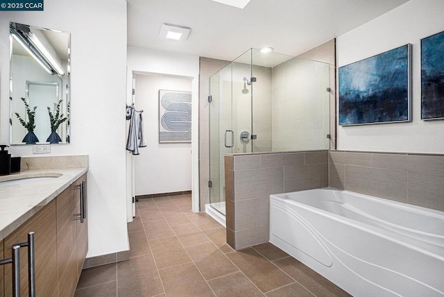 bathroom with tile patterned flooring, vanity, and separate shower and tub