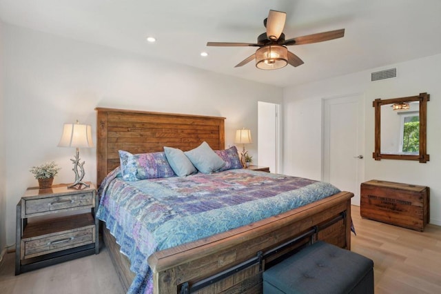 bedroom with ceiling fan and light hardwood / wood-style floors