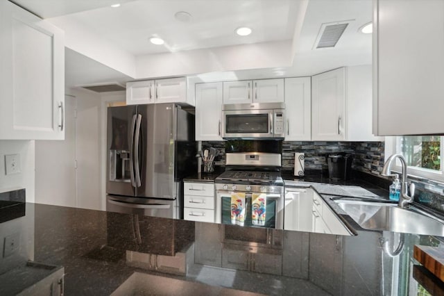 kitchen featuring sink, white cabinets, and appliances with stainless steel finishes