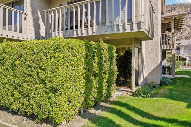 doorway to property with a lawn and a balcony