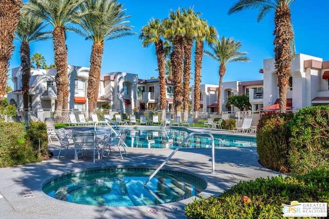 view of pool featuring a community hot tub and a patio area