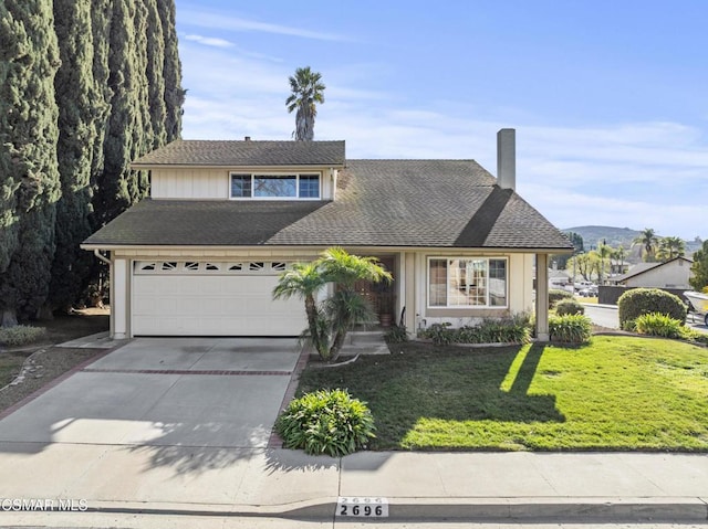 view of front property featuring a garage and a front yard