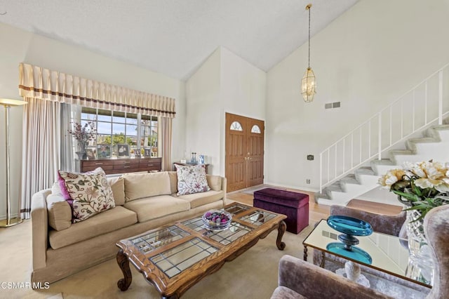 carpeted living room featuring high vaulted ceiling