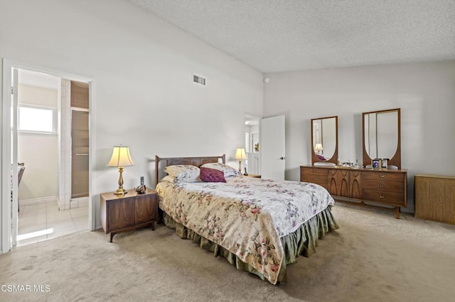 carpeted bedroom with vaulted ceiling and a textured ceiling