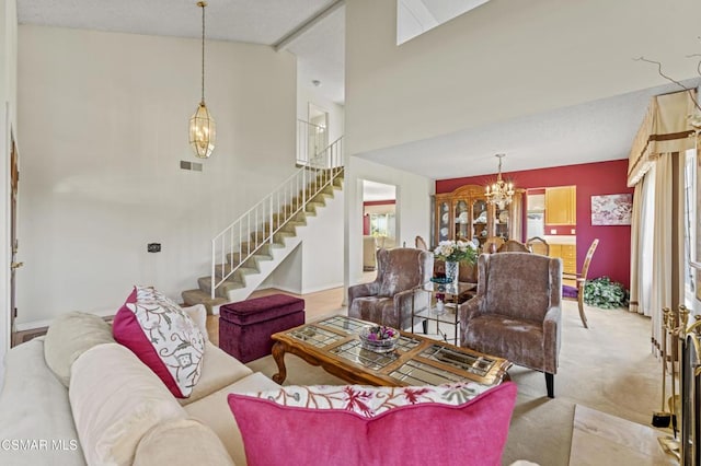 carpeted living room with an inviting chandelier and high vaulted ceiling