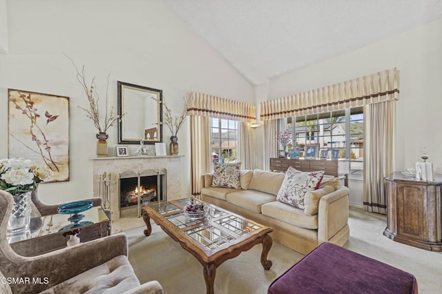 carpeted living room with high vaulted ceiling