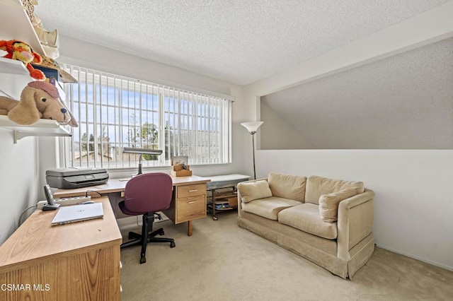 carpeted home office featuring vaulted ceiling and a textured ceiling