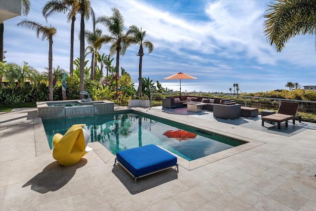 view of pool with an in ground hot tub, a patio area, and a fire pit