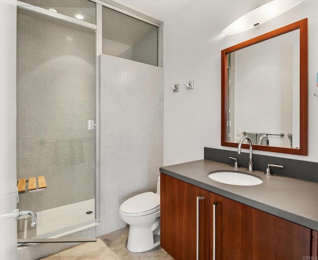 bathroom with tile patterned flooring, vanity, a shower with door, and toilet