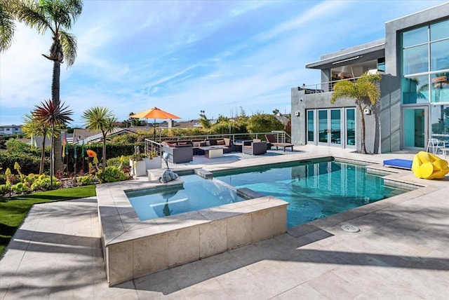 view of swimming pool featuring an outdoor living space with a fire pit, a patio, and an in ground hot tub