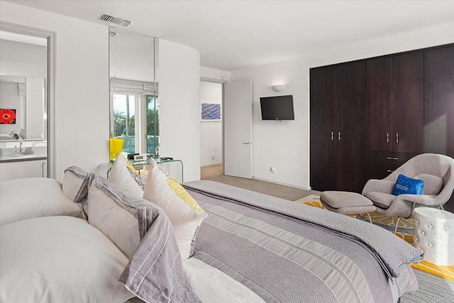 carpeted bedroom featuring sink