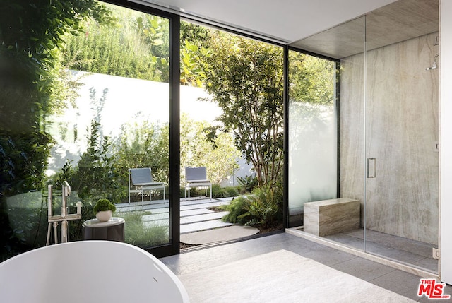 doorway to outside featuring expansive windows