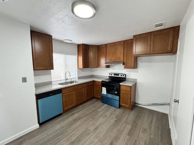 kitchen featuring sink, range with electric cooktop, wood-type flooring, a textured ceiling, and stainless steel dishwasher