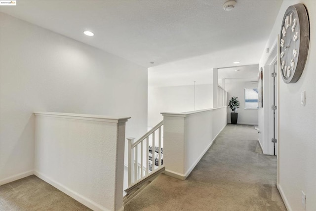 hallway featuring light carpet