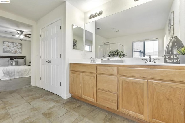 bathroom featuring a shower with door, vanity, and ceiling fan