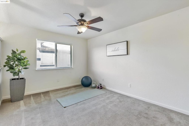 exercise room with ceiling fan