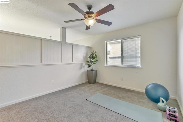 workout area featuring light colored carpet and ceiling fan