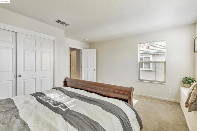 carpeted bedroom featuring a closet