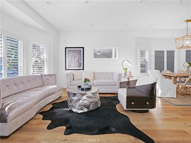 living room featuring light hardwood / wood-style flooring and a chandelier