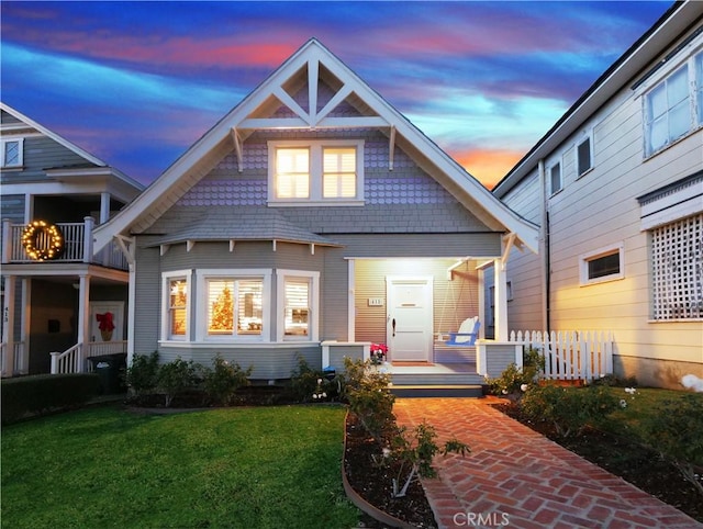 back house at dusk with a yard