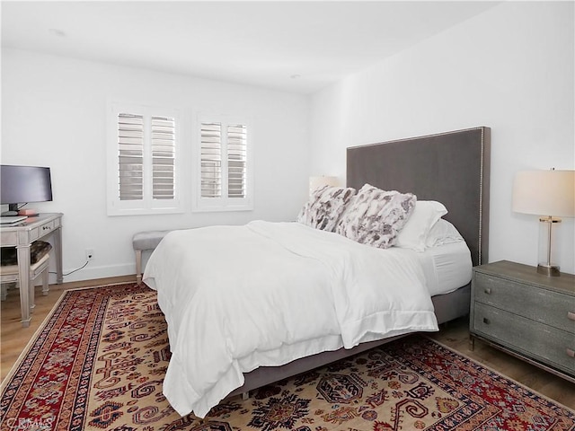 bedroom with hardwood / wood-style floors