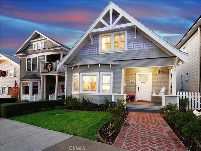 craftsman inspired home with a yard and a balcony