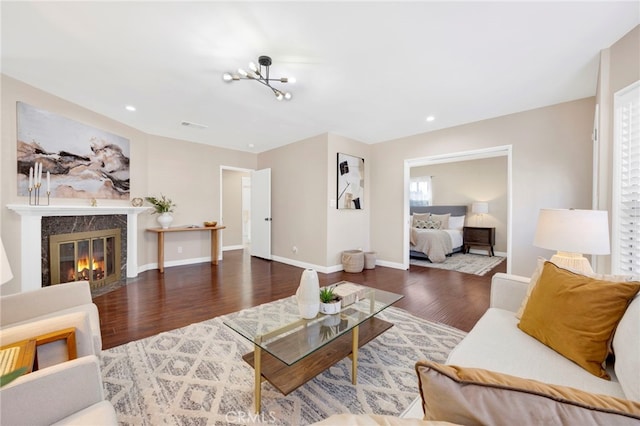 living room featuring a premium fireplace and dark hardwood / wood-style floors