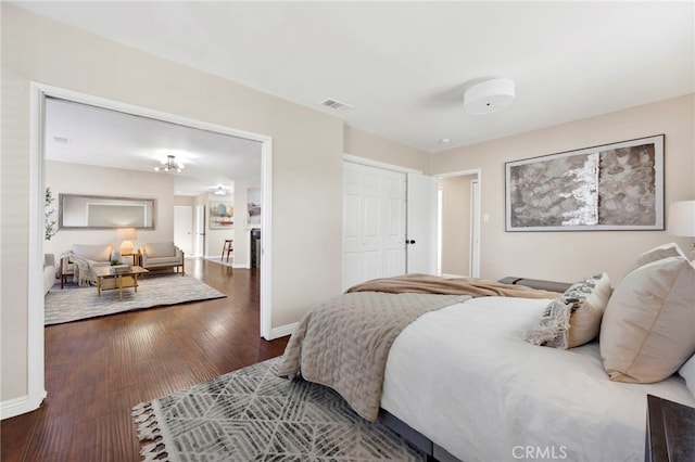 bedroom with wood-type flooring and a closet