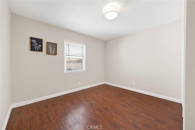 spare room featuring dark wood-type flooring