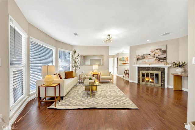 living room featuring hardwood / wood-style flooring and a high end fireplace