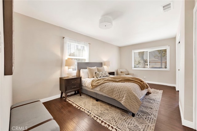 bedroom with dark hardwood / wood-style flooring