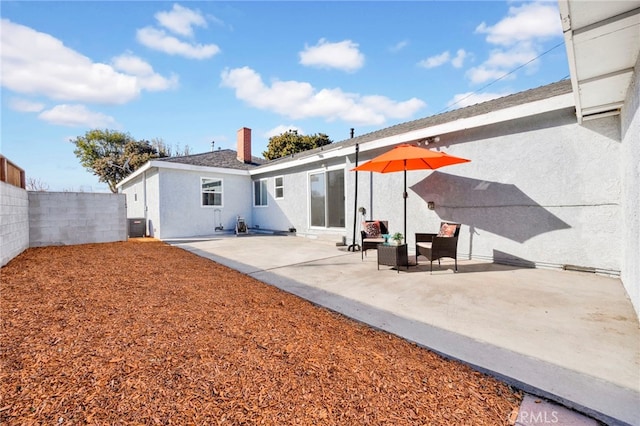 rear view of house featuring a patio and central air condition unit