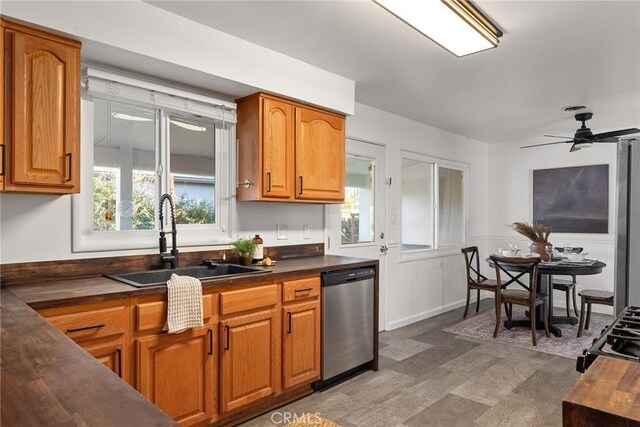 kitchen with ceiling fan, stainless steel dishwasher, and sink