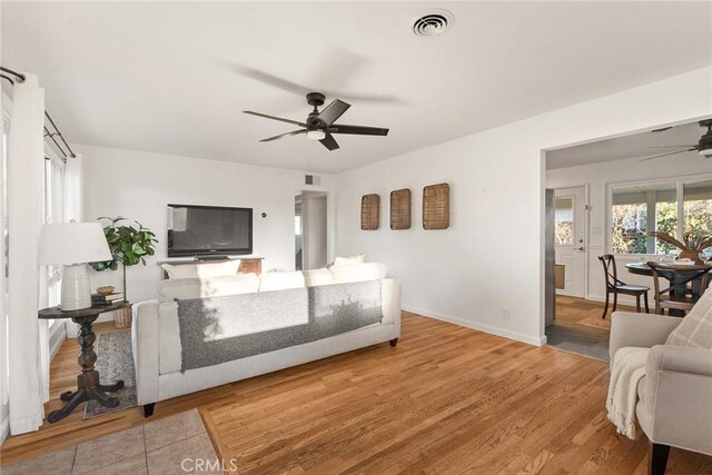 living room featuring ceiling fan and wood-type flooring