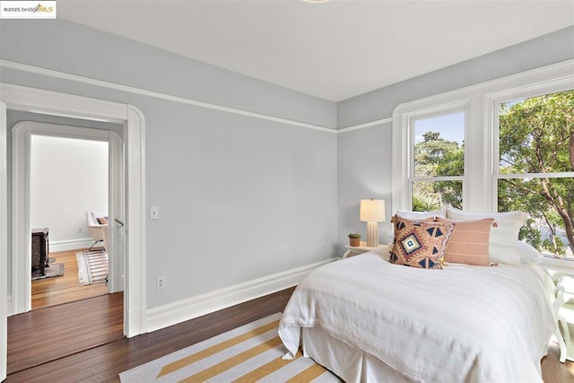 bedroom with dark wood-type flooring