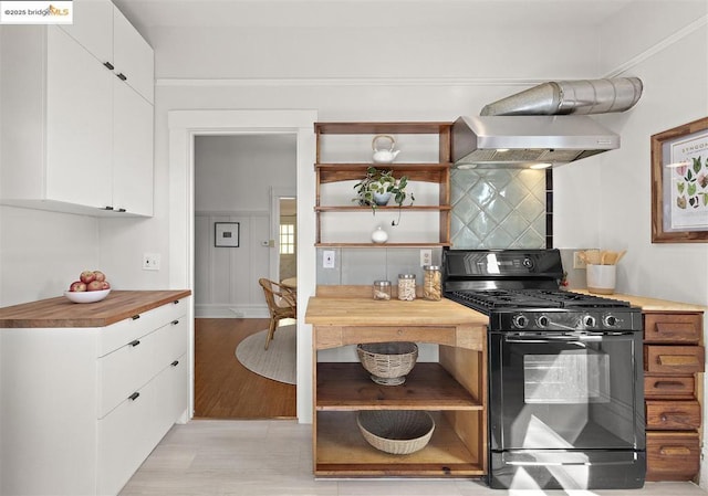 kitchen with white cabinetry, gas stove, wall chimney range hood, and light wood-type flooring