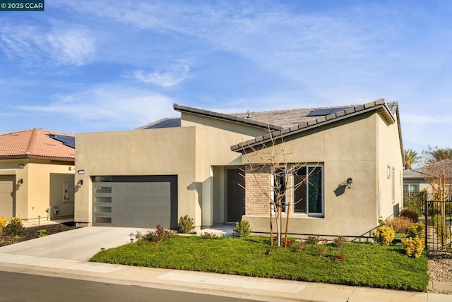 view of front of home featuring a garage and solar panels