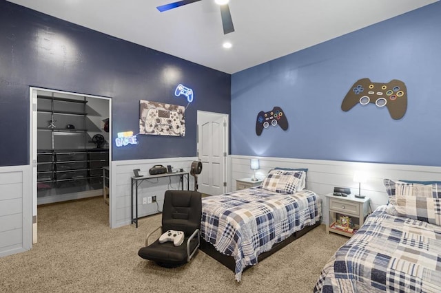 carpeted bedroom featuring ceiling fan and a closet