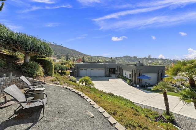 view of front facade with a mountain view and a garage