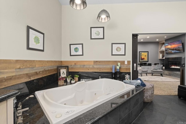 bathroom featuring a relaxing tiled tub and tile patterned floors