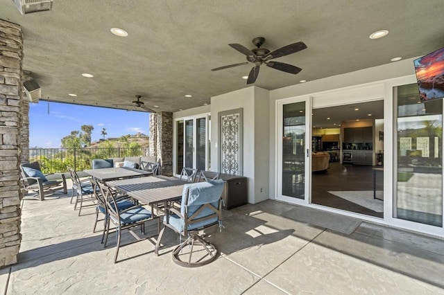 view of patio featuring ceiling fan