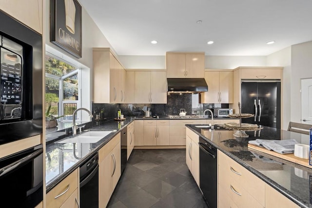 kitchen with light brown cabinetry, tasteful backsplash, sink, dark stone counters, and black appliances