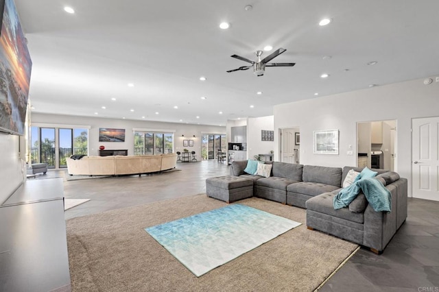 living room featuring concrete floors and ceiling fan