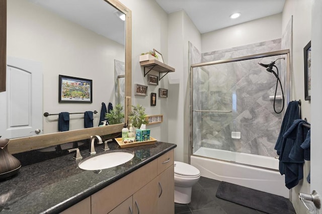 full bathroom with tile patterned flooring, vanity, toilet, and combined bath / shower with glass door