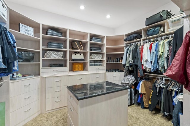 walk in closet featuring light colored carpet